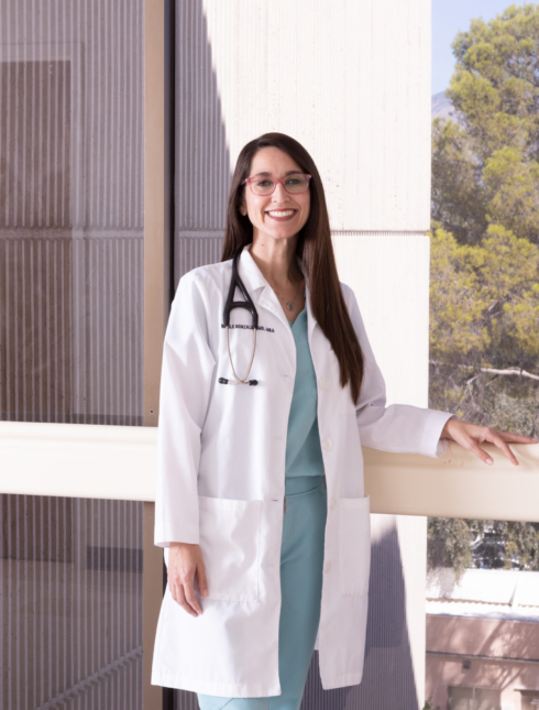 Physician standing by hospital window