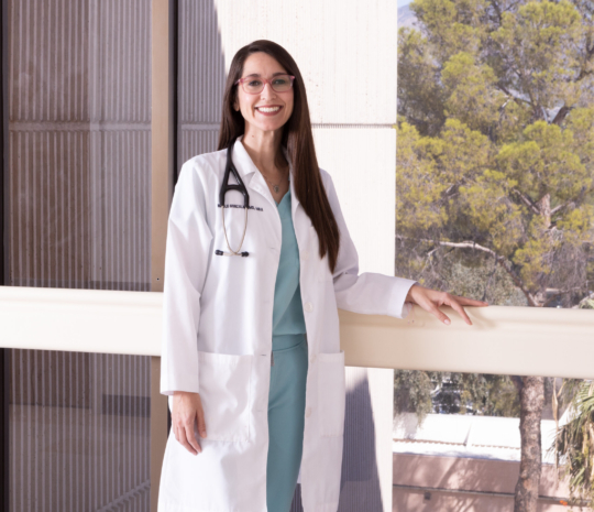 Physician standing by hospital window