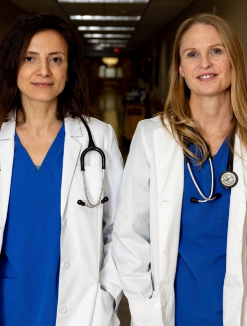 Two physicians in hospital hallway